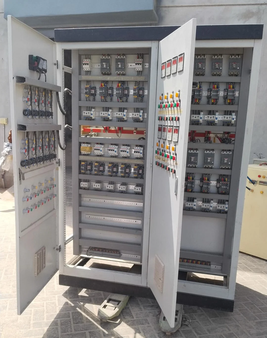 Open electrical control panel of a rice mill showing contactors and breakers