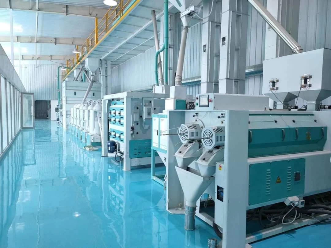 Rice mill machines lined up along a bright, clean mill hall