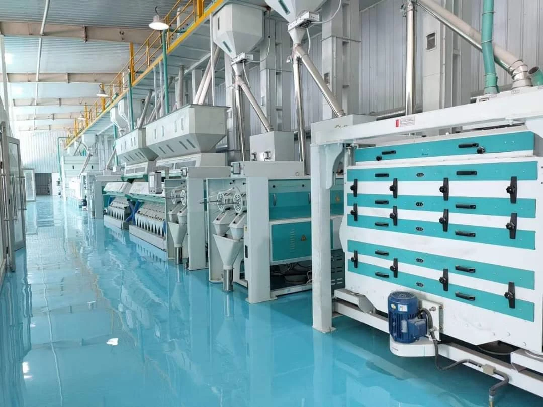 Milling machines fitted along the floor of a rice mill hall